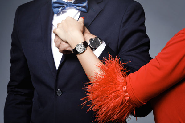 Close-up of couple hands. Well dressed stylish man and woman wearing luxury watches