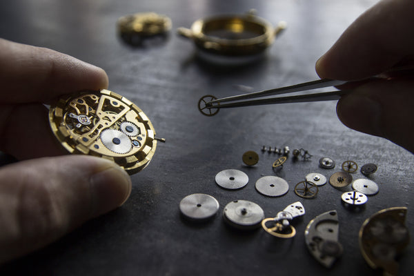 watchmaker repairing classic mechanical watch