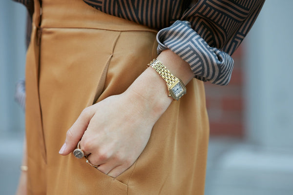Up-close image of woman’s wrist wearing real gold watch
