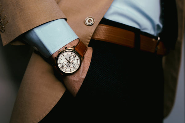 Closeup fashion image of luxury brown watch on wrist of man
