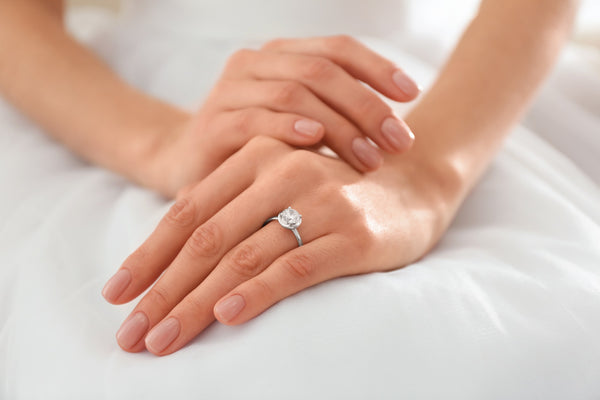 woman wearing white gold engagement ring