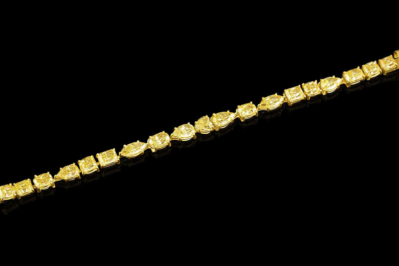 Rivière 18kt Yellow Gold Fancy Intense Yellow Diamond Multi-Shaped Bracelet, GIA Certified